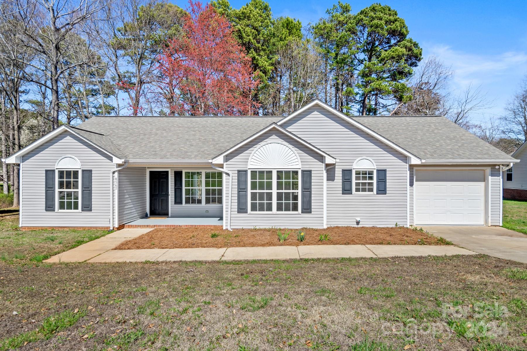 8567 Unity Church Road Denver, NC 28037 - Photo 1 of 38 a front view of a house with a yard and garage