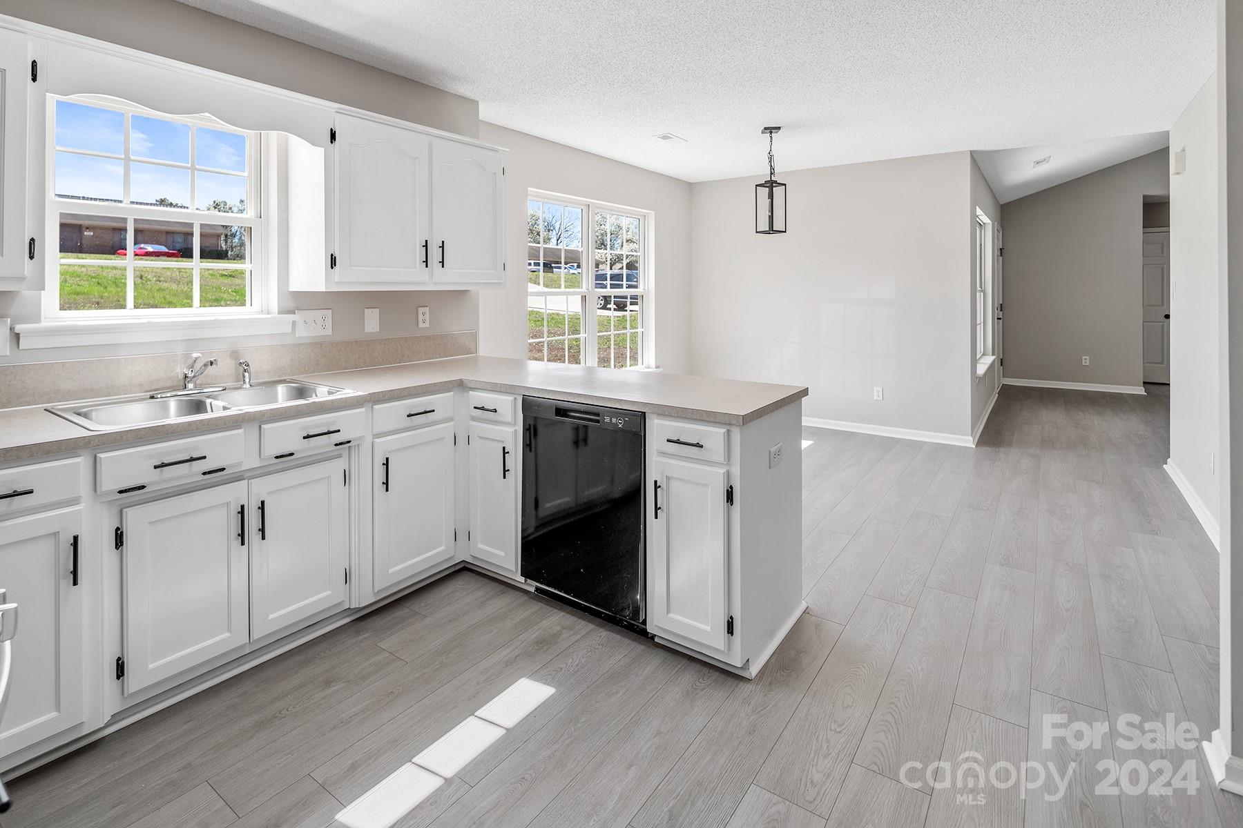 8567 Unity Church Road Denver, NC 28037 - Photo 11 of 38 a kitchen with a sink cabinets appliances and a window