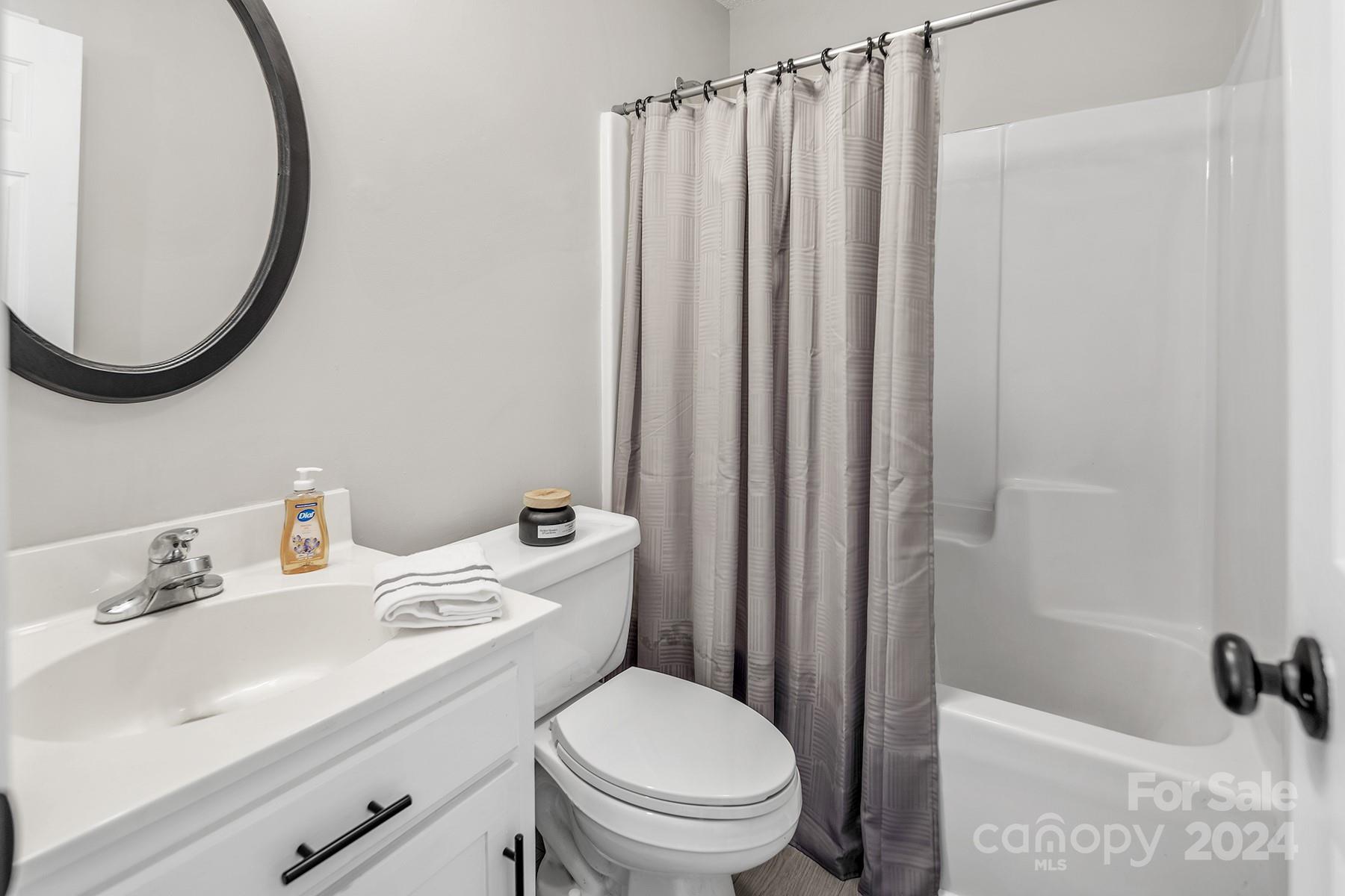 8567 Unity Church Road Denver, NC 28037 - Photo 25 of 38 a bathroom with a sink a toilet and a mirror