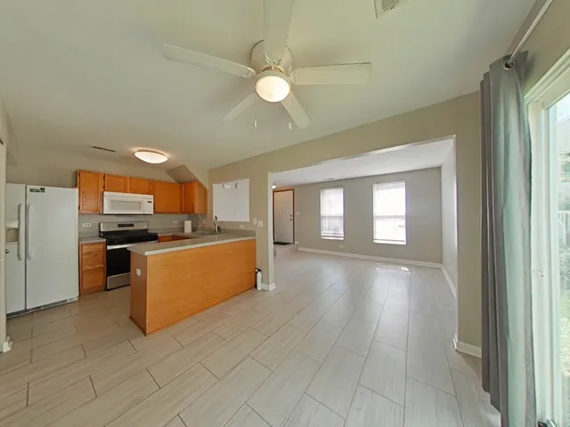 a view of a kitchen with a sink and a large window