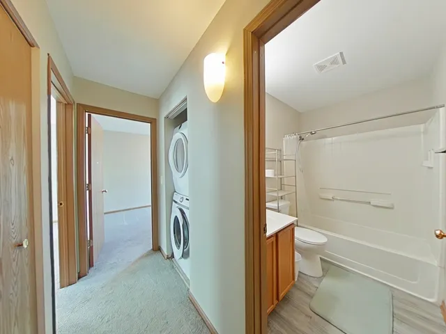 a bathroom with a granite countertop shower and a toilet