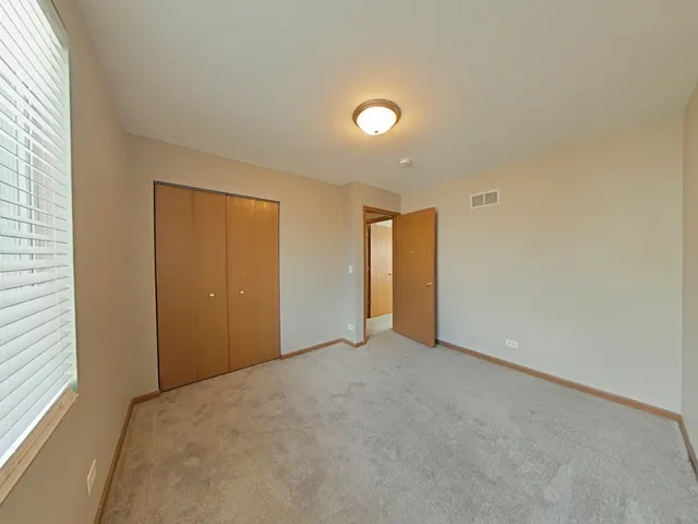a view of an empty room and a window
