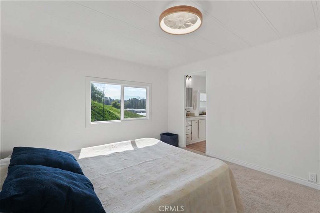 31130 South General Kearny Road, Unit 136 Temecula, CA 92591 - Photo 43 of 65 a bedroom with a bed and a window