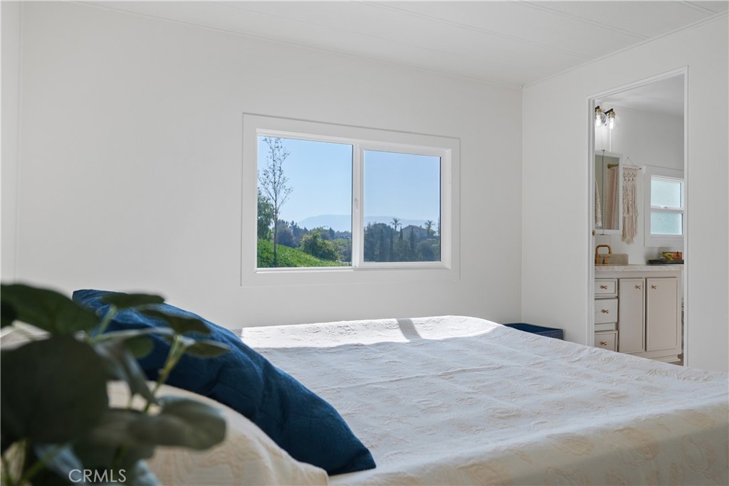31130 South General Kearny Road, Unit 136 Temecula, CA 92591 - Photo 44 of 65 a view of a bedroom with a bed and wooden floor