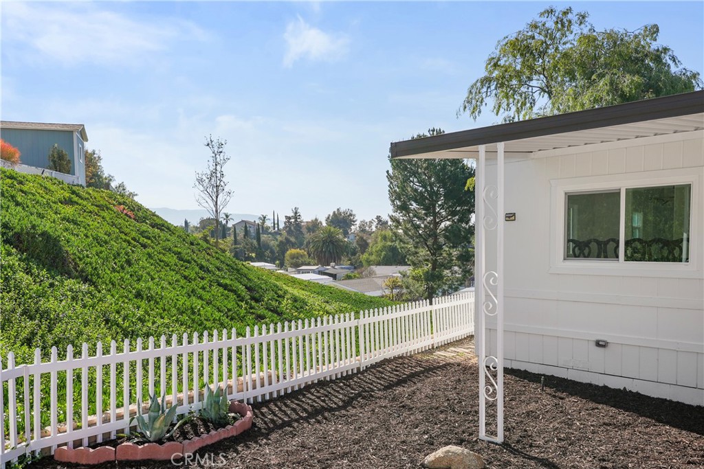 31130 South General Kearny Road, Unit 136 Temecula, CA 92591 - Photo 49 of 65 a view of a house with a small yard and wooden fence