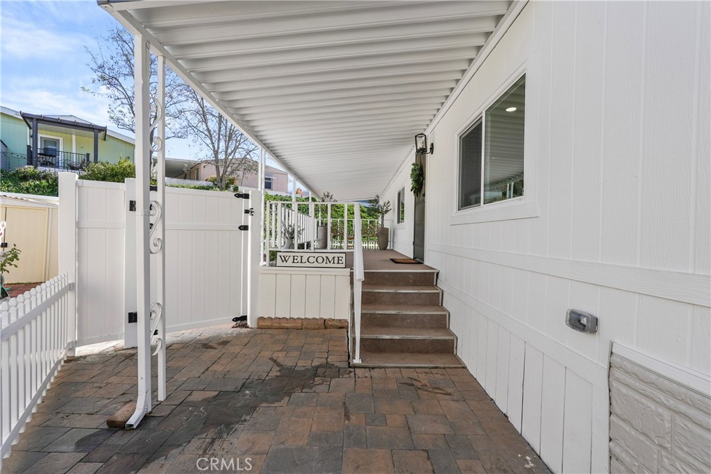 31130 South General Kearny Road, Unit 136 Temecula, CA 92591 - Photo 7 of 65 Front approach to home- to front door and to enclosed side yard