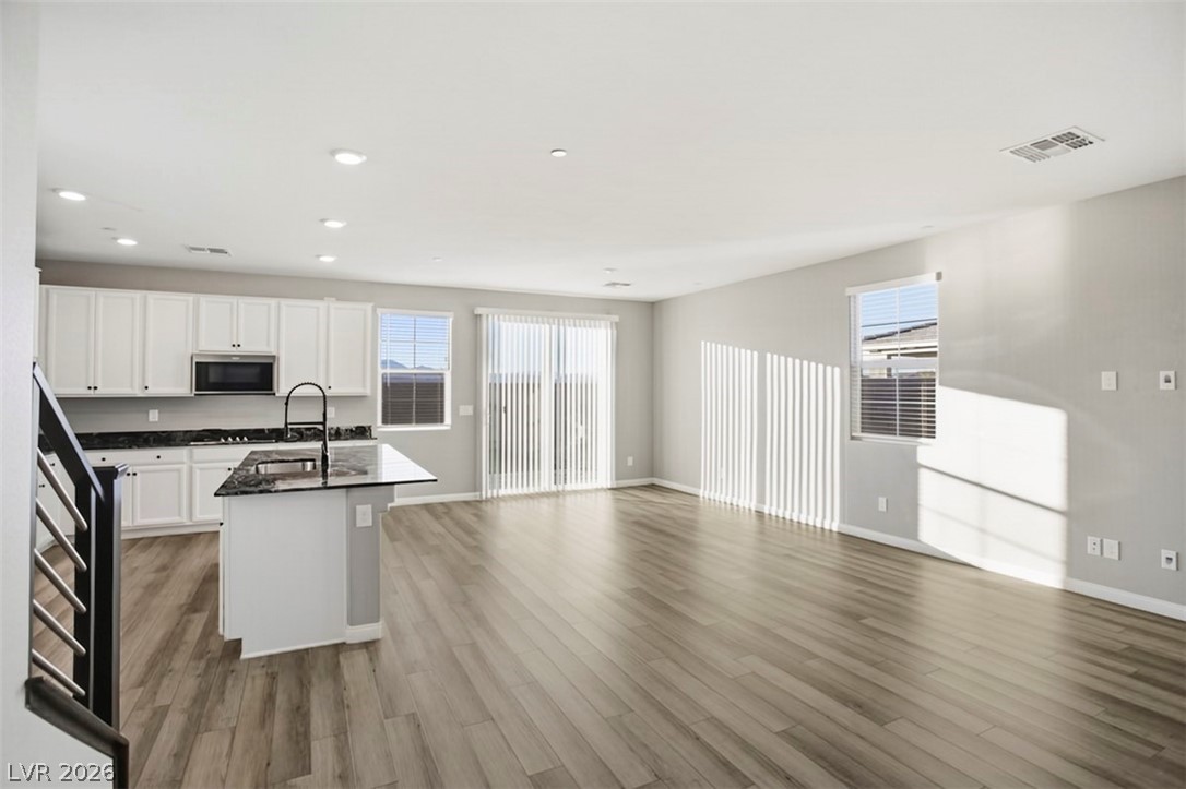 2865 Mincio Street Henderson, NV 89044 - Photo 28 of 33 Kitchen with open floor plan, a kitchen island with sink, white cabinets, recessed lighting, and plenty of natural light