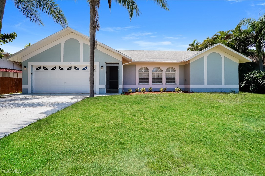 18257 Columbine Road Fort Myers, FL 33967 - Photo 1 of 16 a view of a house with a big yard and large trees