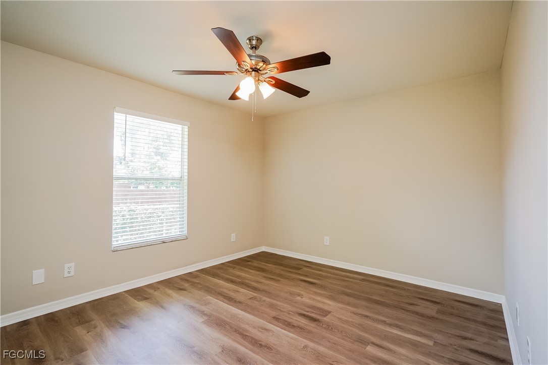 18257 Columbine Road Fort Myers, FL 33967 - Photo 11 of 16 an empty room with wooden floor fan and windows