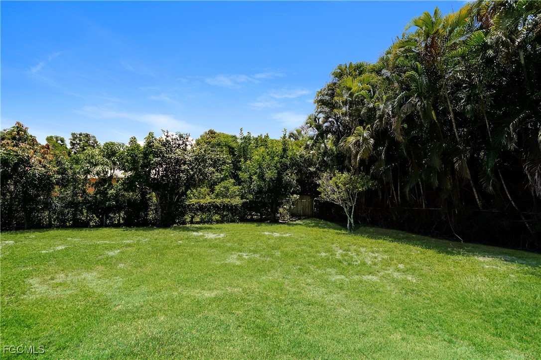 18257 Columbine Road Fort Myers, FL 33967 - Photo 16 of 16 a view of a green yard with a house in the background