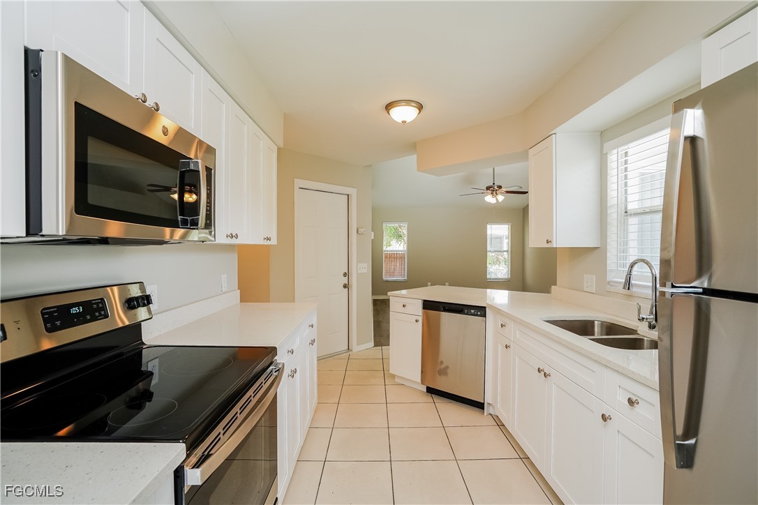 18257 Columbine Road Fort Myers, FL 33967 - Photo 6 of 16 a kitchen with a sink a stove and microwave