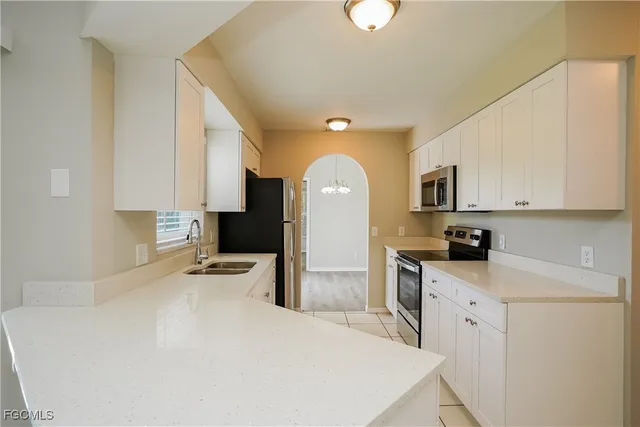 a kitchen with a stove a sink and a refrigerator