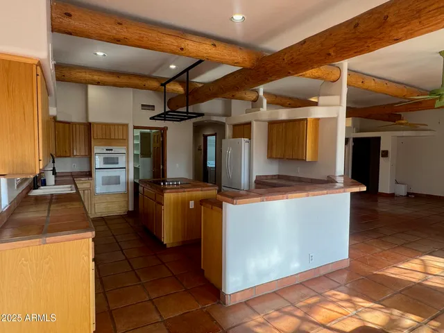 a kitchen with refrigerator and cabinets