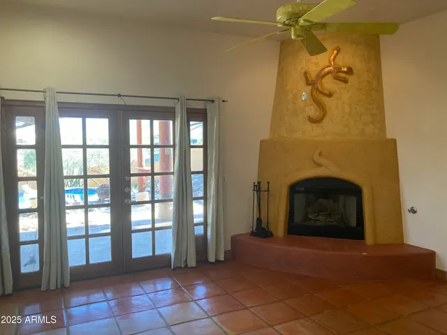 a view of a livingroom with a fireplace and window