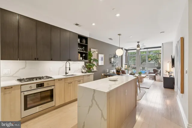 a large white kitchen with a large window