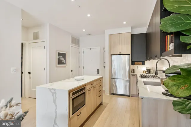 a kitchen with a sink appliances and cabinets
