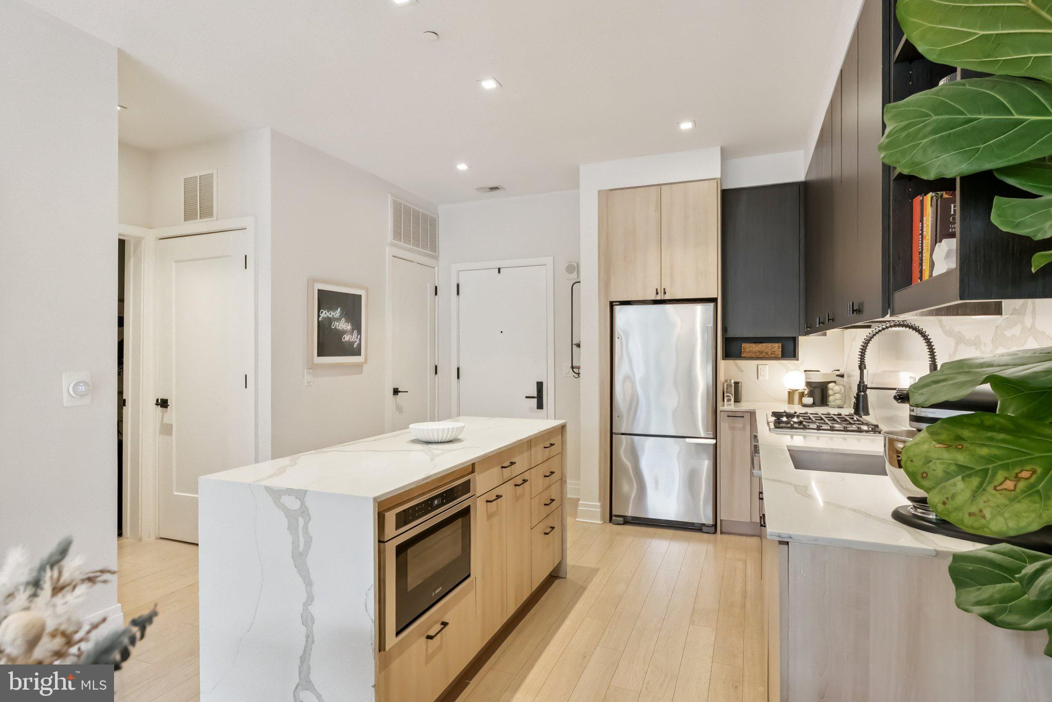 900 11th Street Southeast, Unit 106 Washington, DC 20003 - Photo 12 of 26 a kitchen with a sink appliances and cabinets