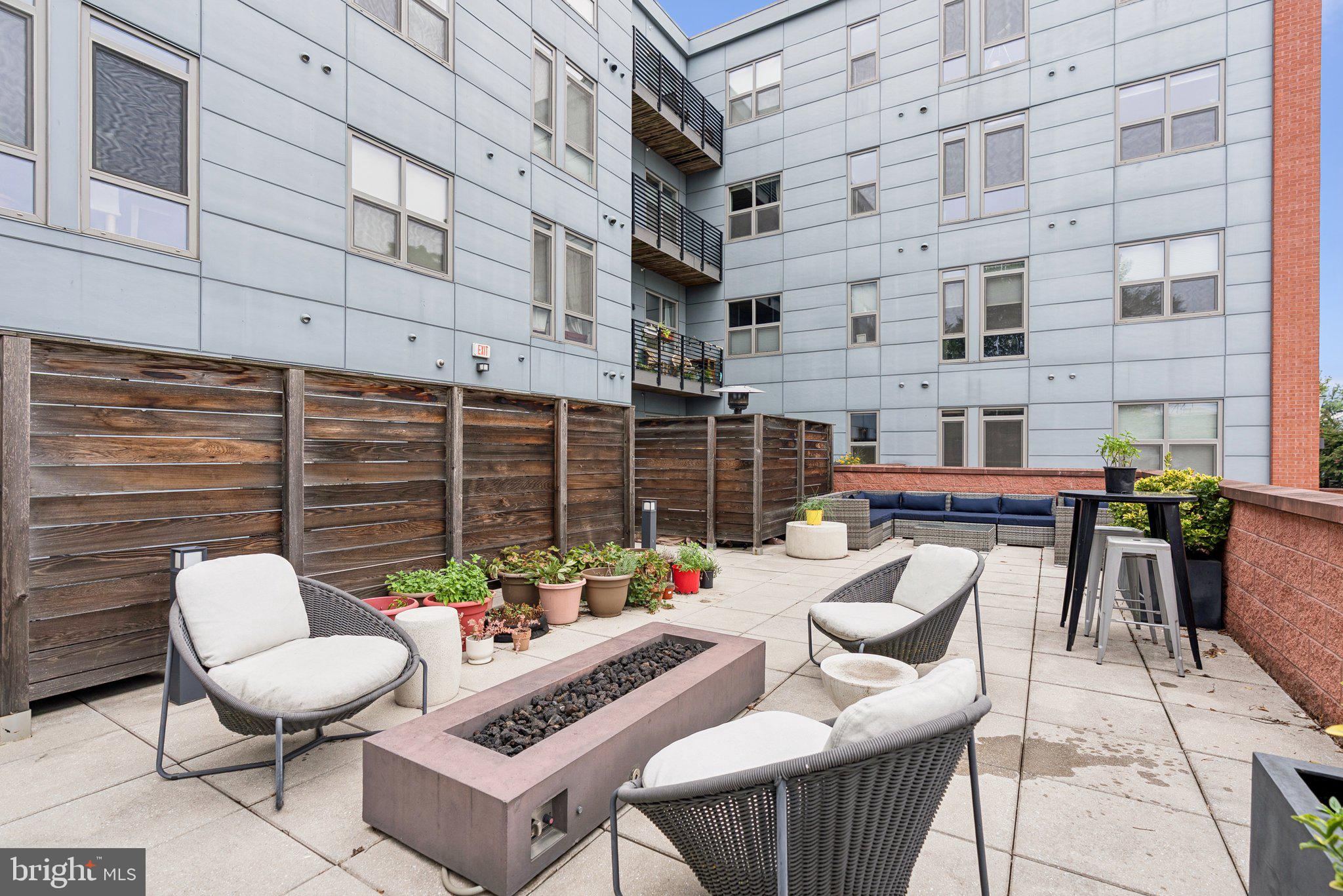 900 11th Street Southeast, Unit 106 Washington, DC 20003 - Photo 24 of 26 a view of a patio with couches table and chairs and potted plants