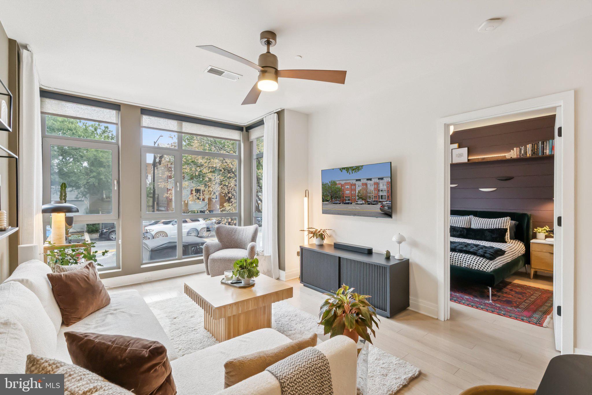 900 11th Street Southeast, Unit 106 Washington, DC 20003 - Photo 3 of 26 a living room with furniture and a large window
