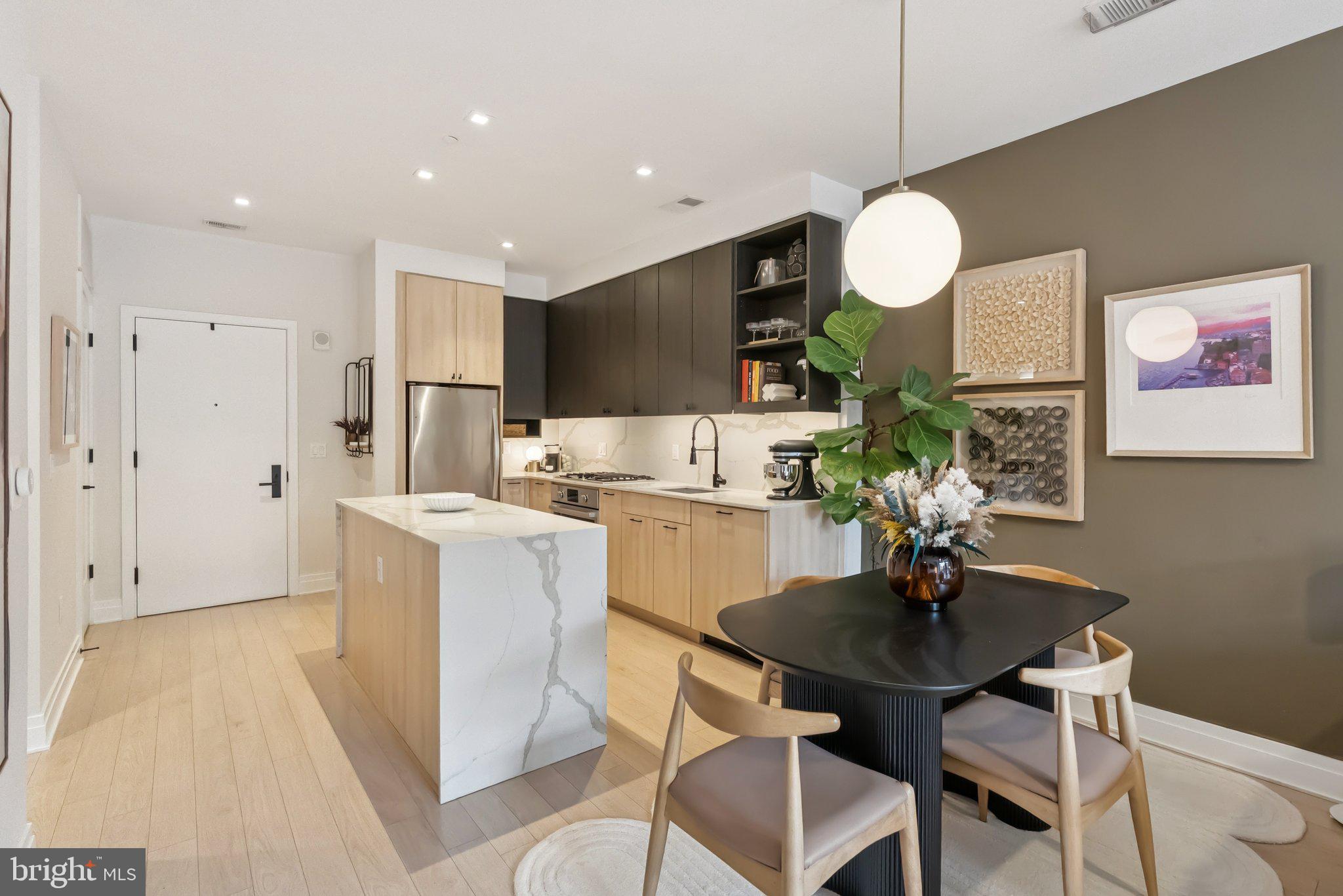 900 11th Street Southeast, Unit 106 Washington, DC 20003 - Photo 8 of 26 a kitchen with a dining table cabinets and a counter top space
