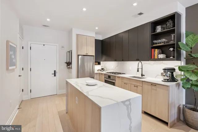 a kitchen with a sink a stove a refrigerator and cabinets
