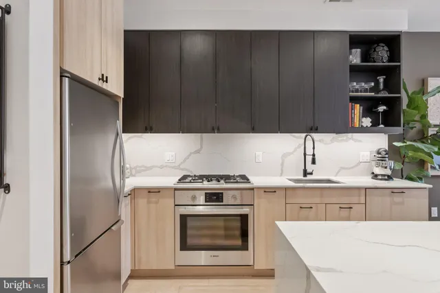 a kitchen with a stove and a refrigerator