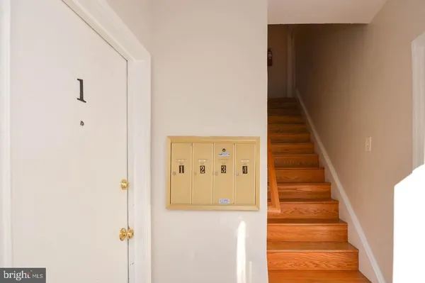 a view of a hallway with wooden floor and entryway