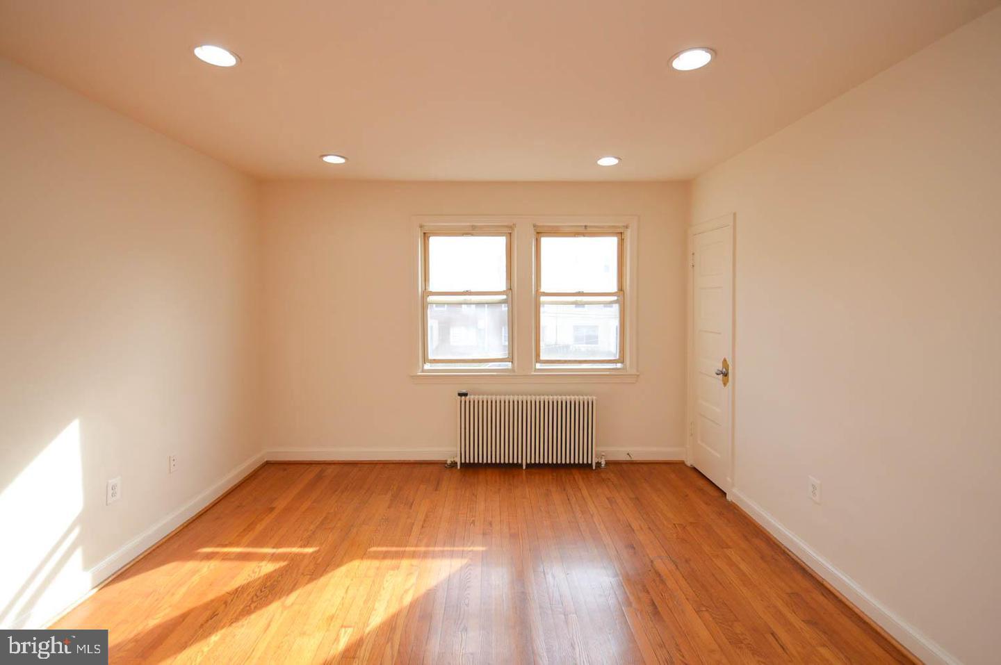 1722 T Street Southeast Washington, DC 20020 - Photo 7 of 23 an empty room with wooden floor and windows