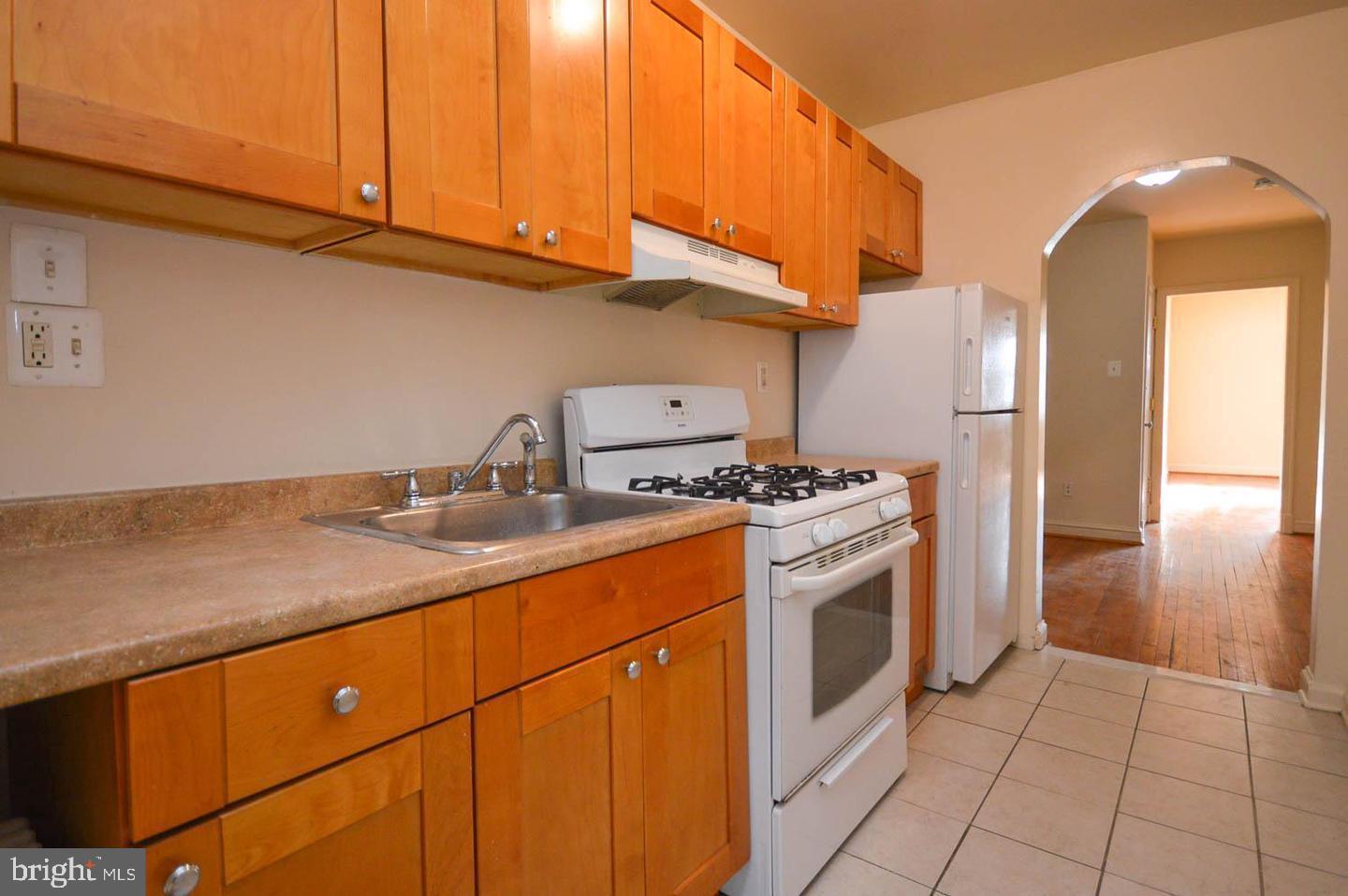 1722 T Street Southeast Washington, DC 20020 - Photo 10 of 23 a kitchen with stainless steel appliances granite countertop a sink a stove and a refrigerator