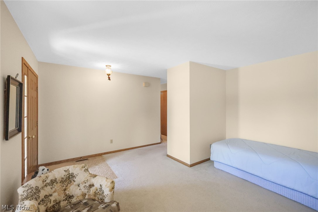 Unfurnished bedroom featuring light colored carpet