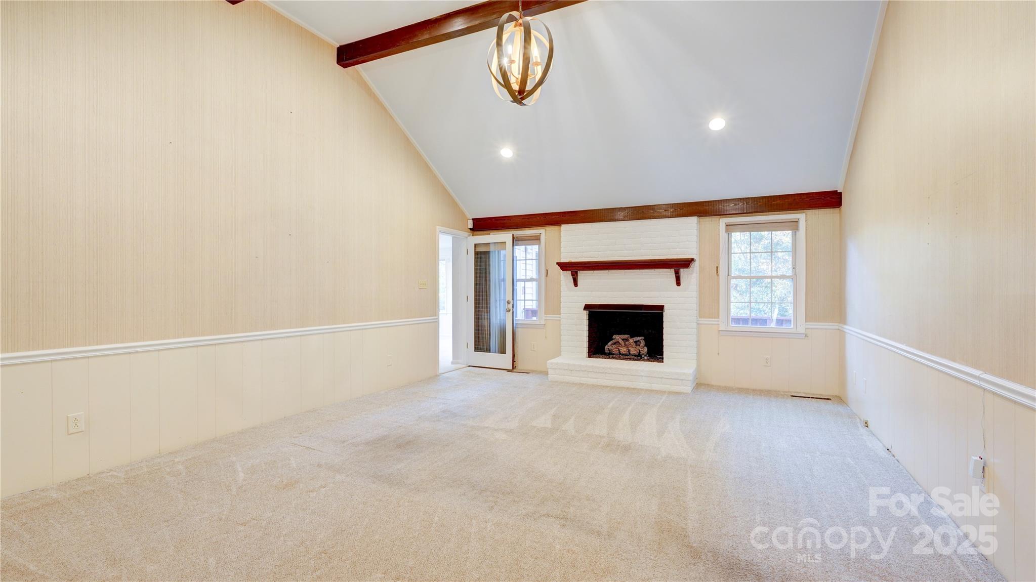1535 Cripple Creek Road Kannapolis, NC 28081 - Photo 2 of 40 a view of an empty room with a fireplace and a window