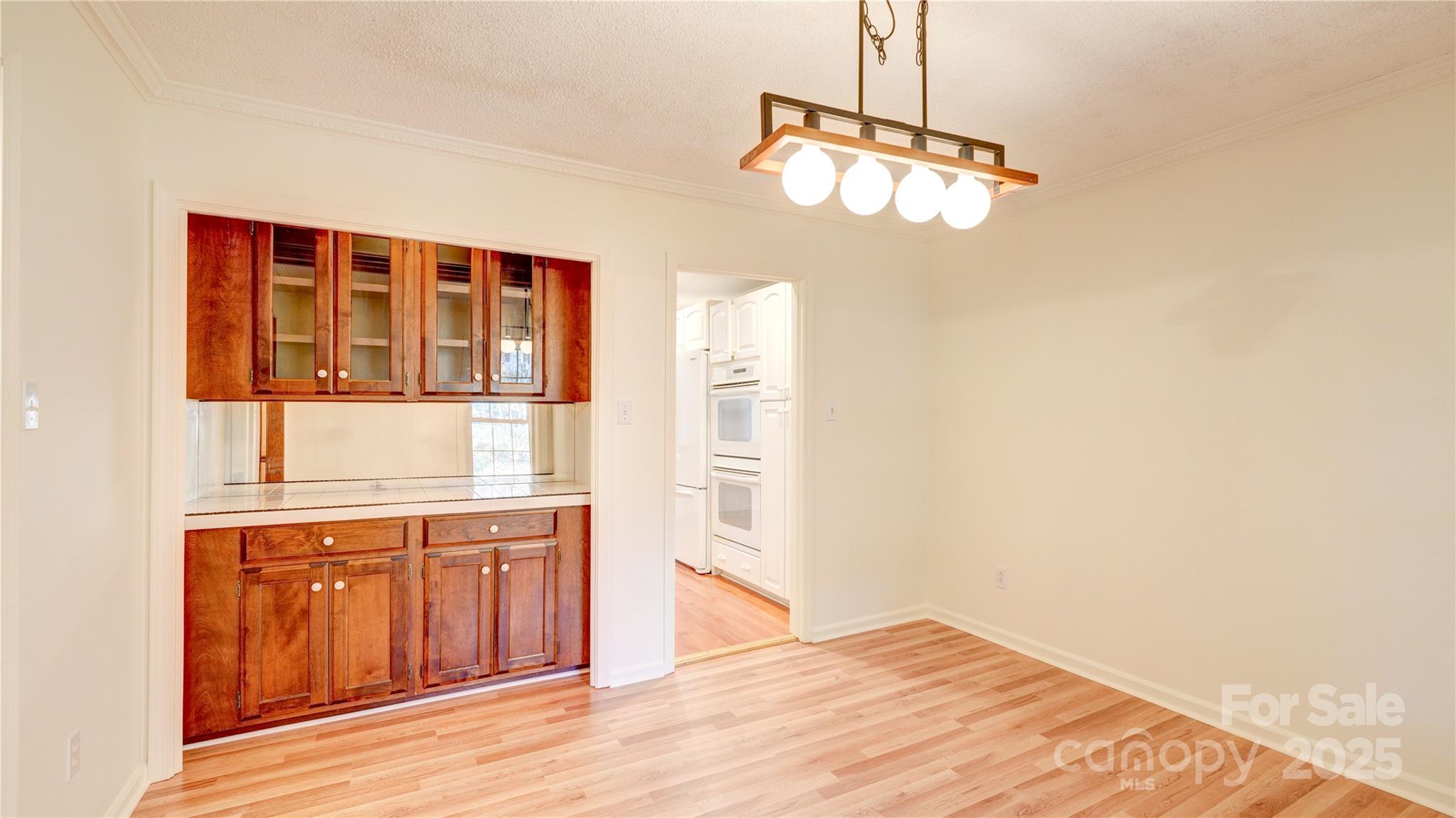 1535 Cripple Creek Road Kannapolis, NC 28081 - Photo 21 of 40 a view of a kitchen with wooden floor and a cabinet