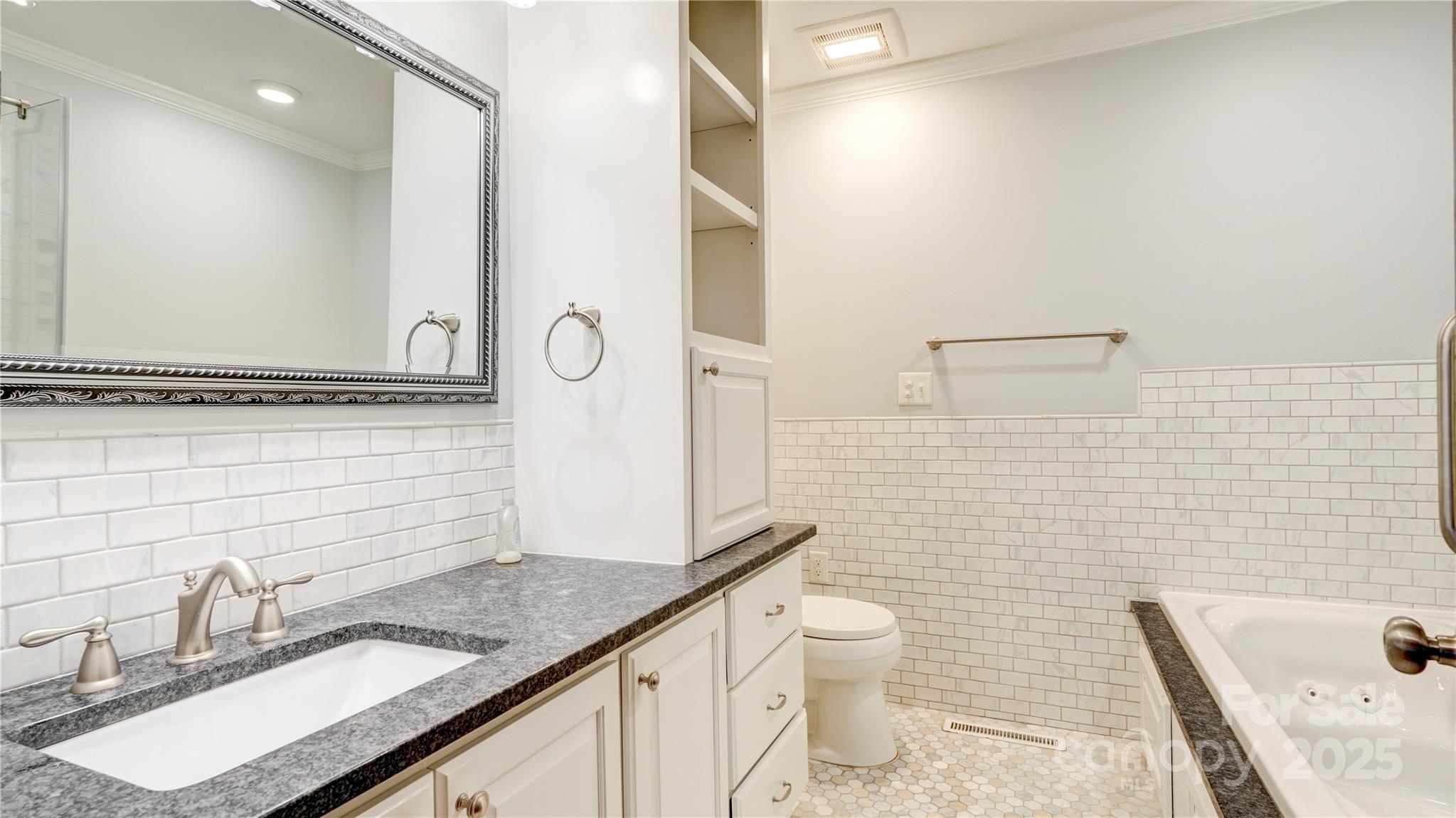1535 Cripple Creek Road Kannapolis, NC 28081 - Photo 5 of 40 a bathroom with a granite countertop toilet sink and mirror