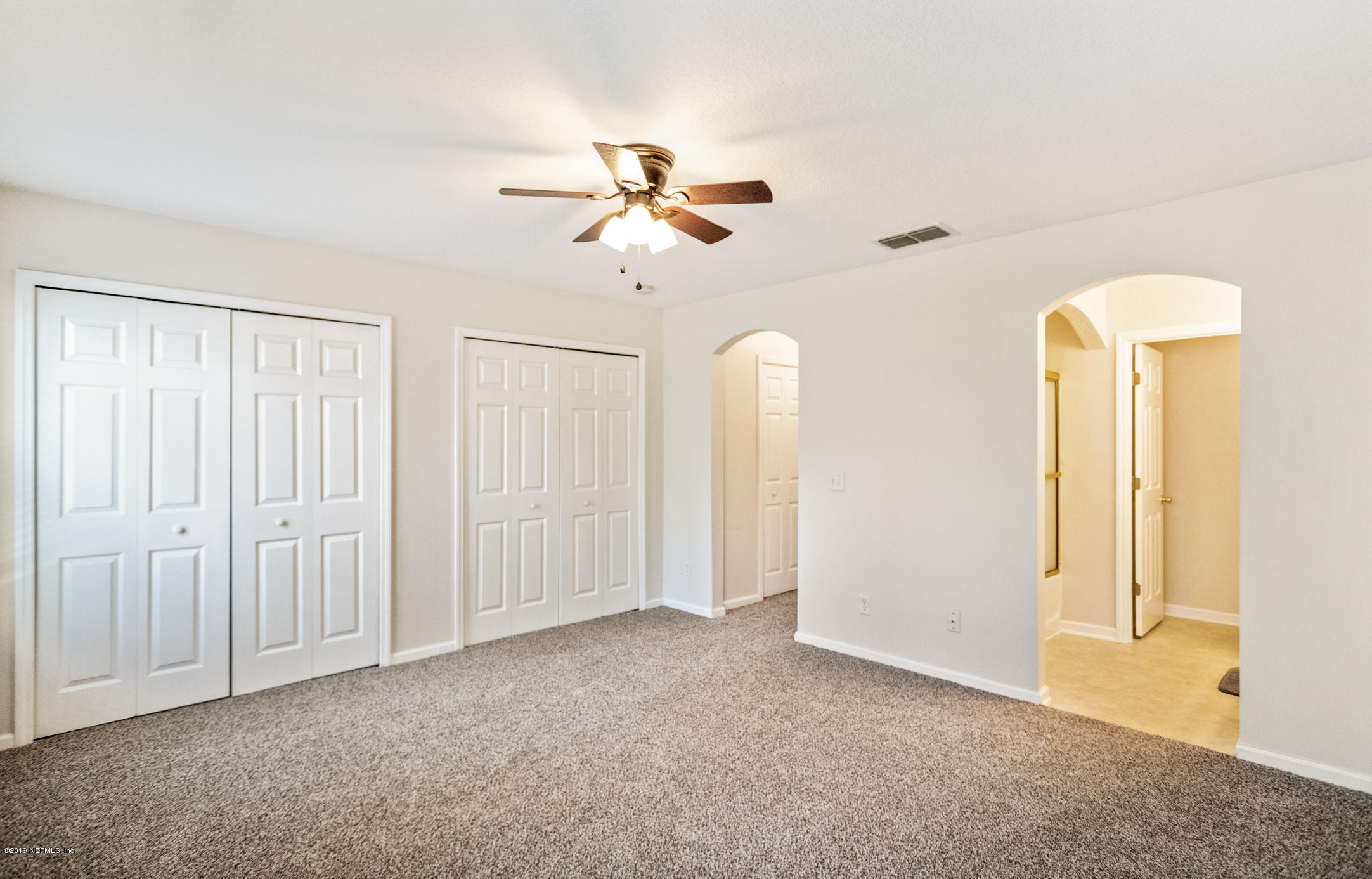 4685 Barnes Road South Jacksonville, FL 32207 - Photo 17 of 29 an empty room with windows and fan