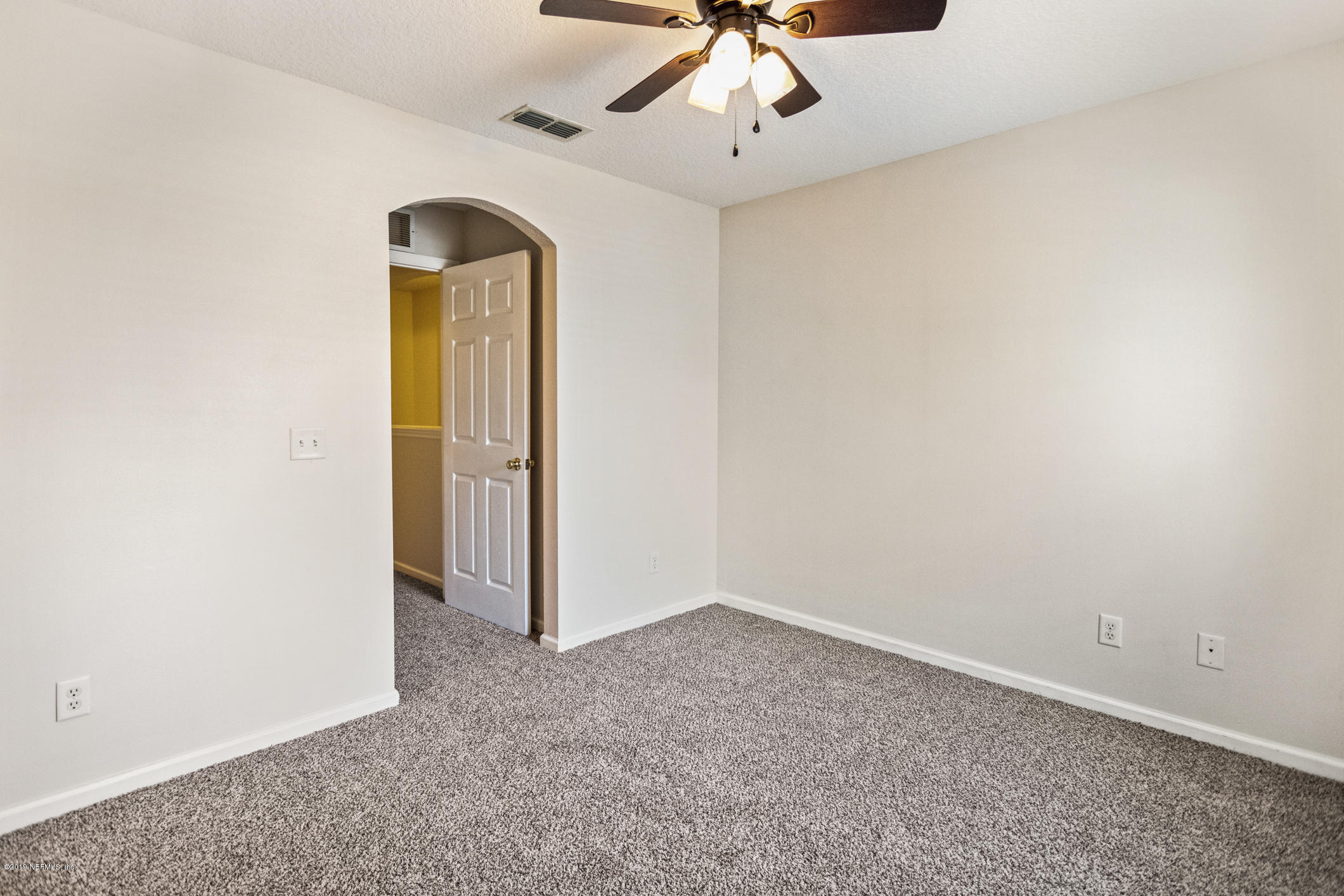 4685 Barnes Road South Jacksonville, FL 32207 - Photo 24 of 29 an empty room with a chandelier fan