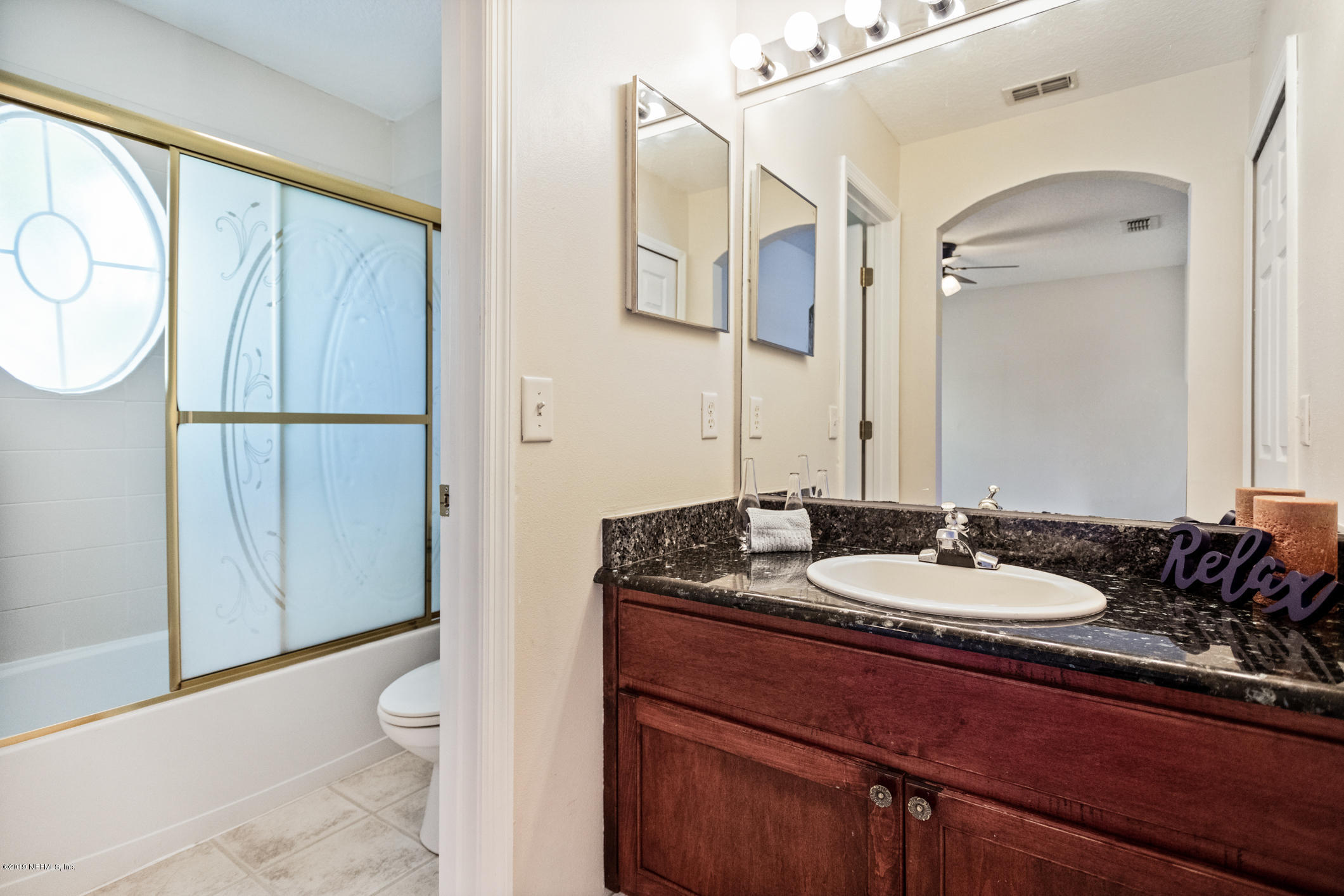 4685 Barnes Road South Jacksonville, FL 32207 - Photo 25 of 29 a bathroom with a granite countertop sink mirror vanity and toilet