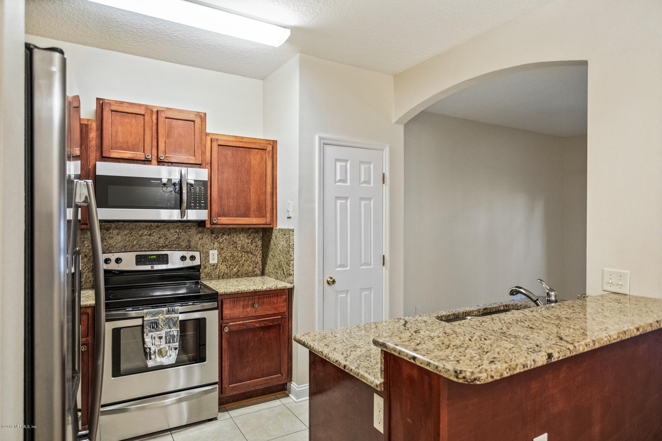 4685 Barnes Road South Jacksonville, FL 32207 - Photo 8 of 29 a kitchen with stainless steel appliances granite countertop a stove and a microwave