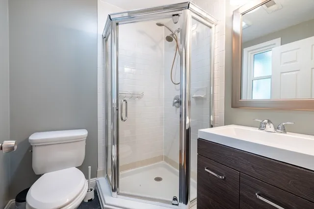 a white toilet sitting next to a bathroom sink