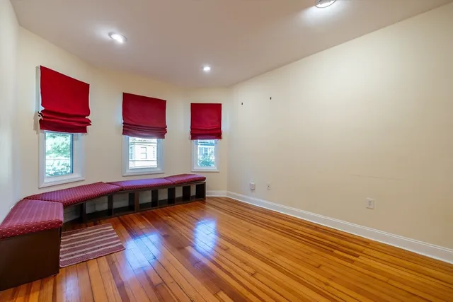 a view of a room with wooden floor and window