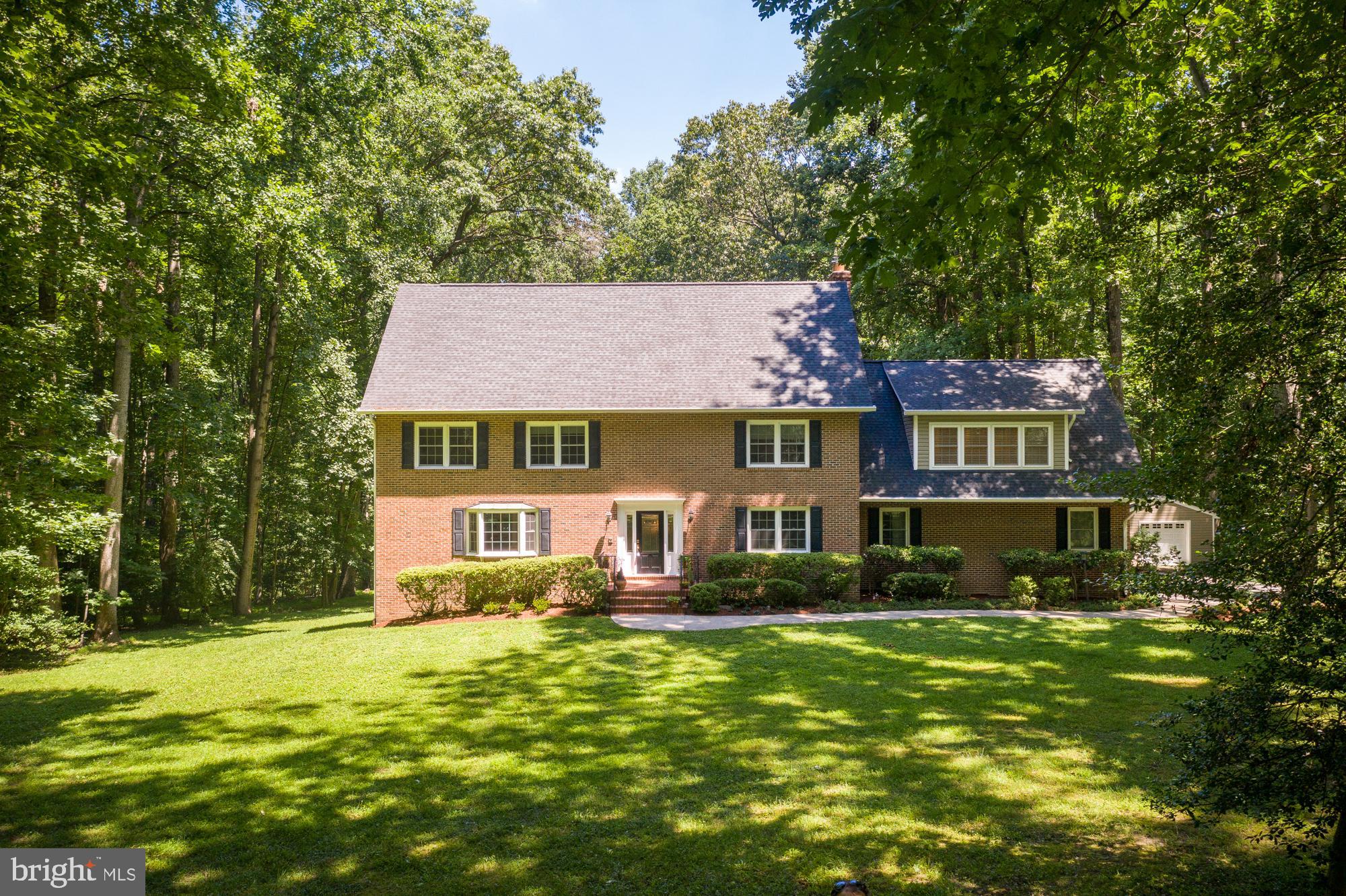 636 Springvale Road Great Falls, VA 22066 - Photo 54 of 59 a front view of a house with a yard table and chairs