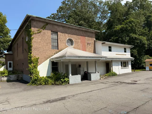 a room with furniture a flat screen tv and a window