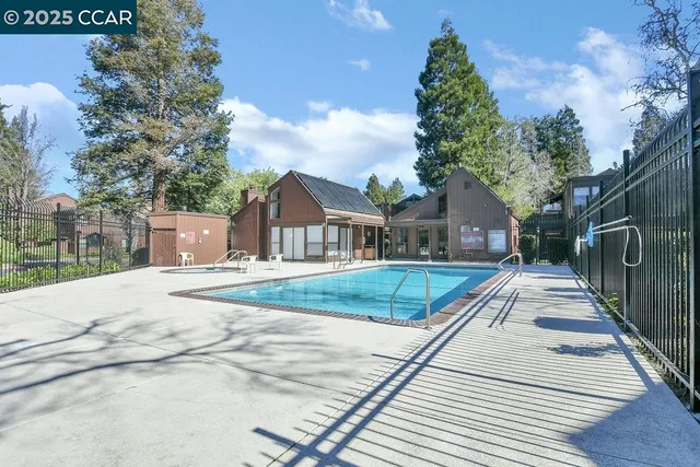 a view of house with outdoor space and trees