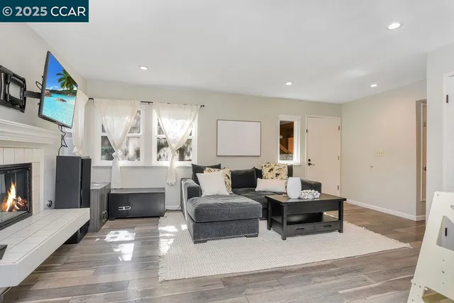 a living room with furniture and a fireplace