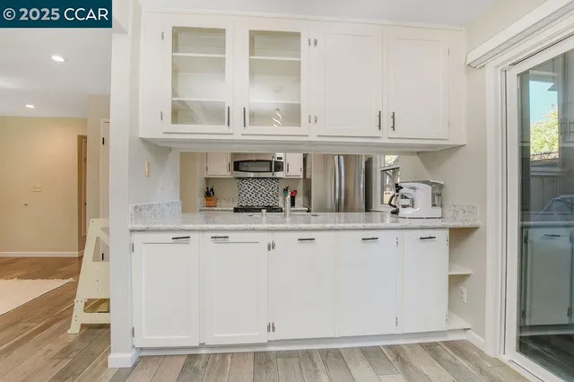 a kitchen with stainless steel appliances granite countertop a sink and cabinets