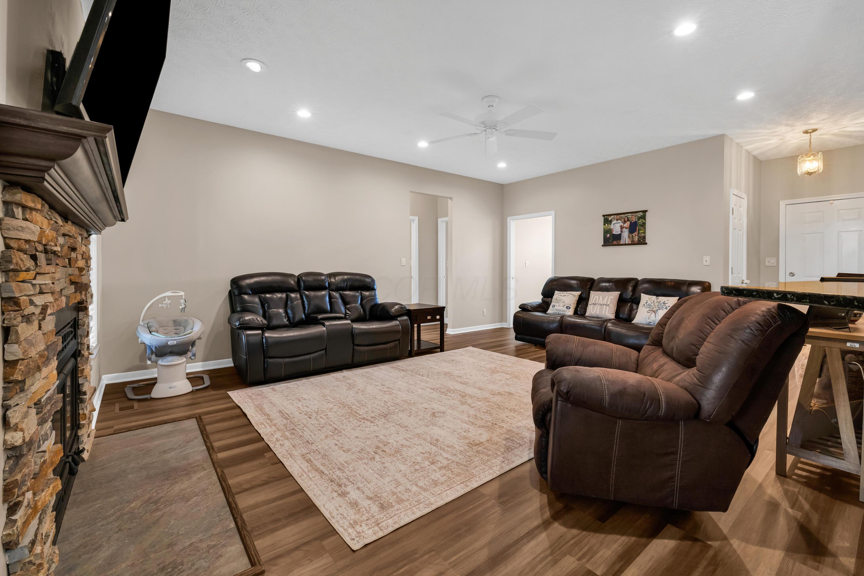 14396 Blamer Road Johnstown, OH 43031 - Photo 10 of 48 • New luxury vinyl plank
flooring ~ 2026
• Tan painted walls
• Can lighting
• Ceiling fan
• Stacked, stone fireplace
with mantle & woodburning
stove insert
• 2” blinds