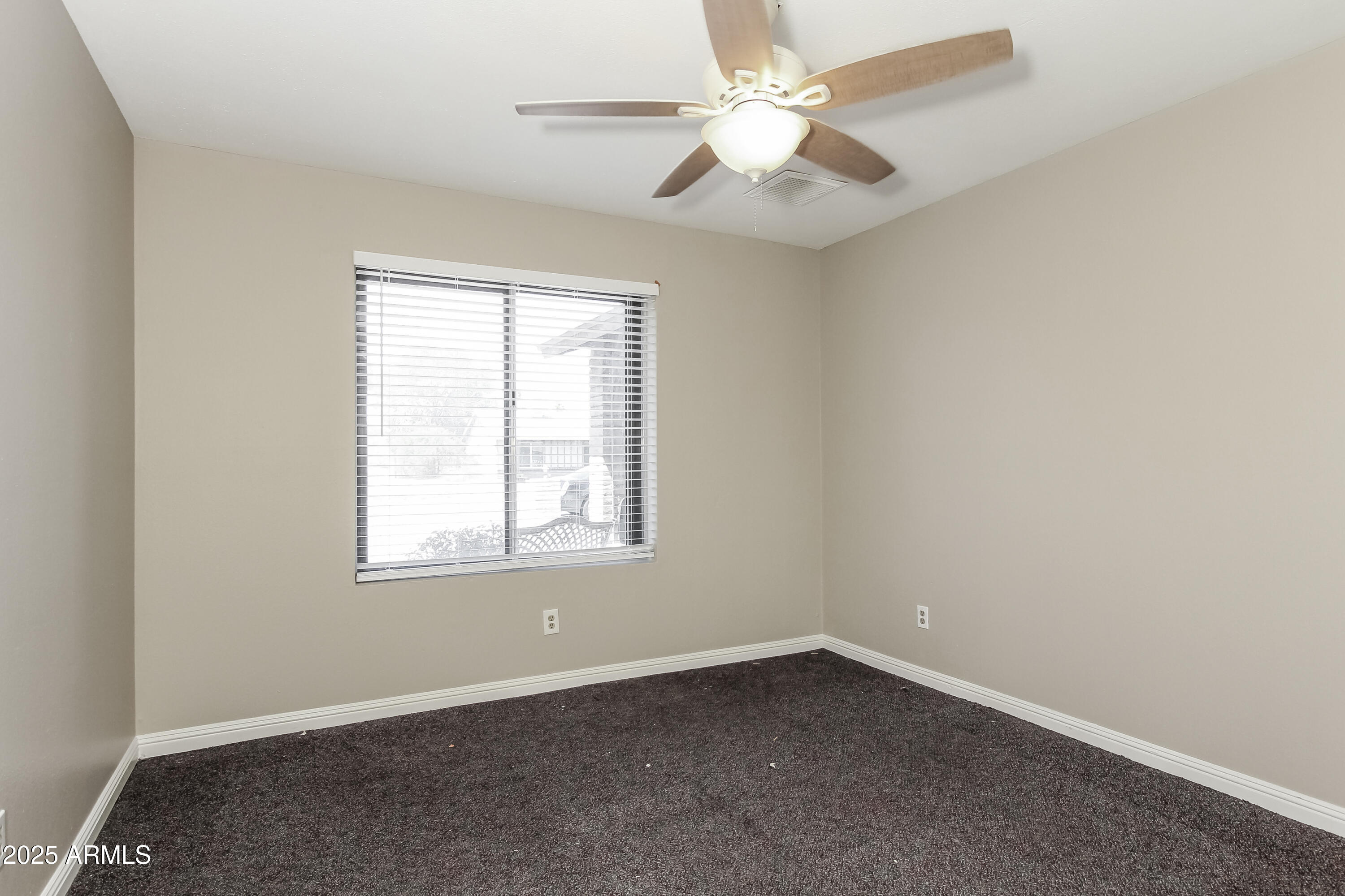 2839 West Wagoner Road Phoenix, AZ 85053 - Photo 10 of 15 an empty room with a window and a fan