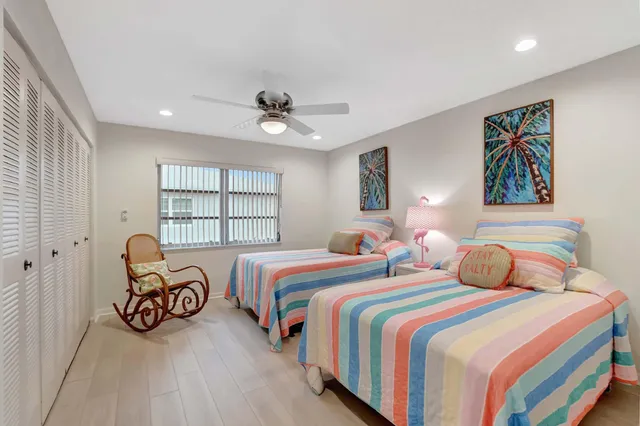 a bedroom with two beds and a large window