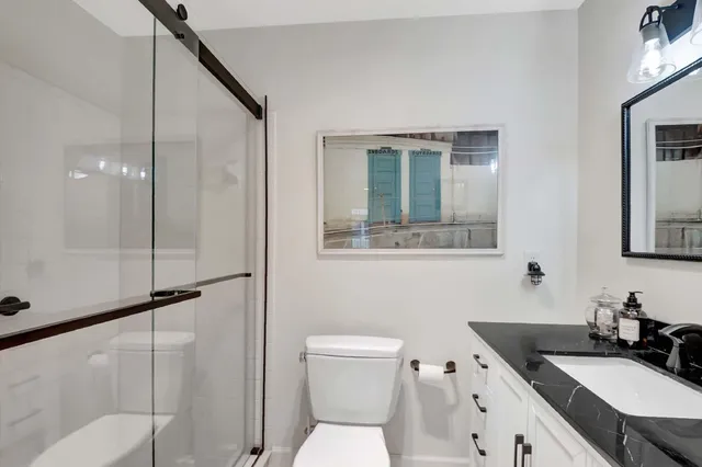 a bathroom with a sink toilet and shower