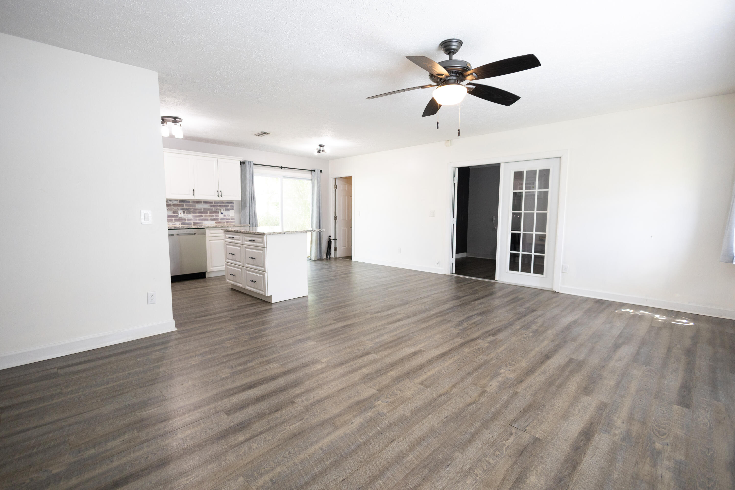 1914 Southwest Beauregard Street Port St. Lucie, FL 34953 - Photo 12 of 23 a view of empty room with wooden floor and ceiling fan
