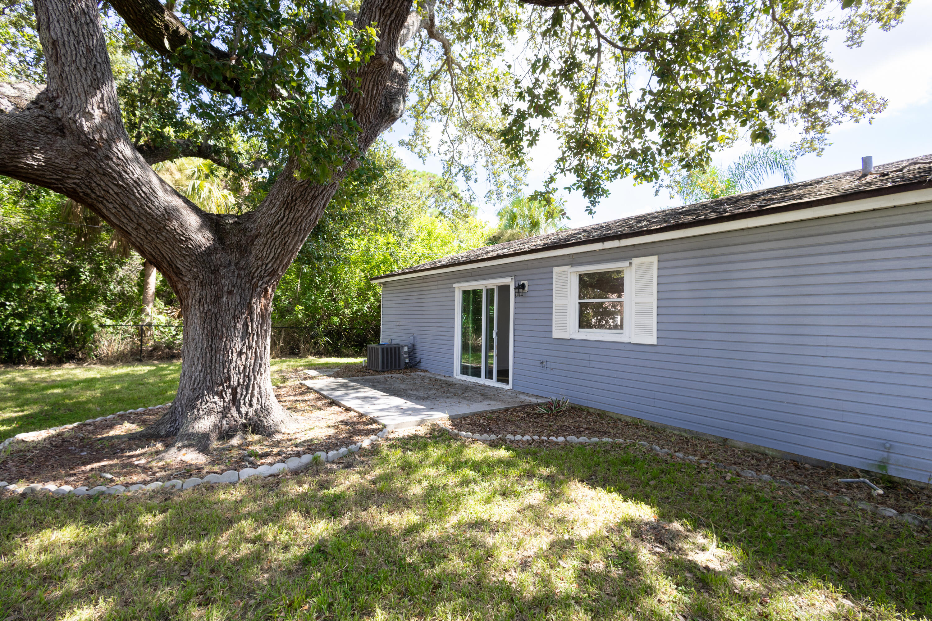 1914 Southwest Beauregard Street Port St. Lucie, FL 34953 - Photo 3 of 23 a view of a house with a tree in a yard